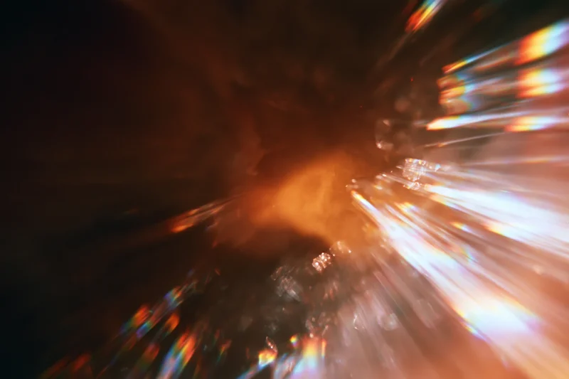 Abstract light streaks radiating from a central point in low-light motion blur