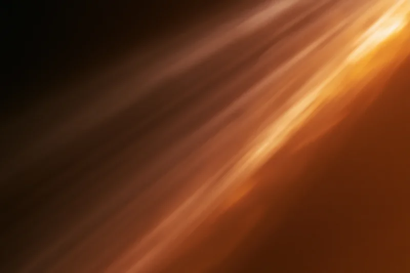 Warm light streaks moving diagonally across a dark abstract background