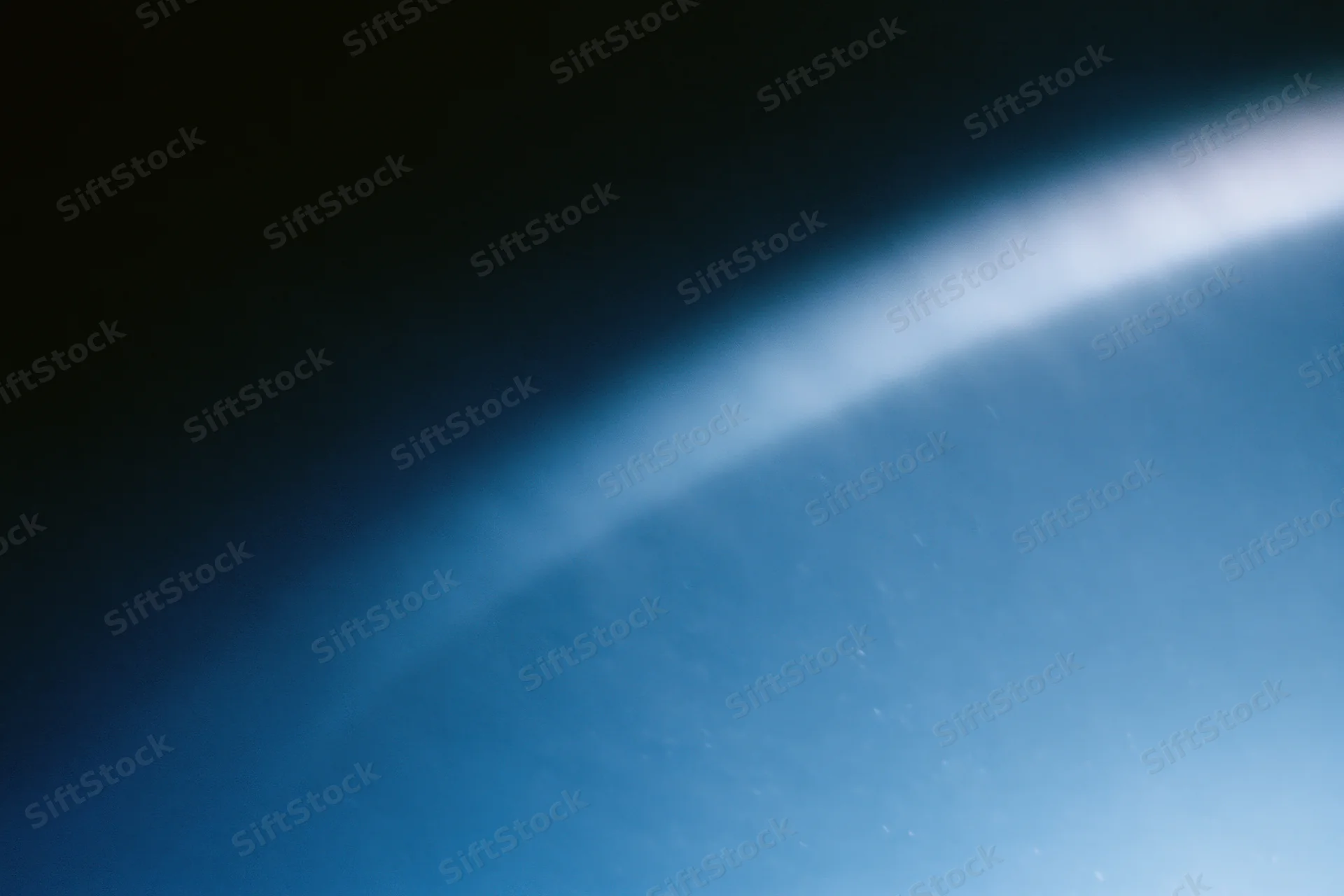 Soft blue light gradient fading from deep navy to bright white across a curved horizon