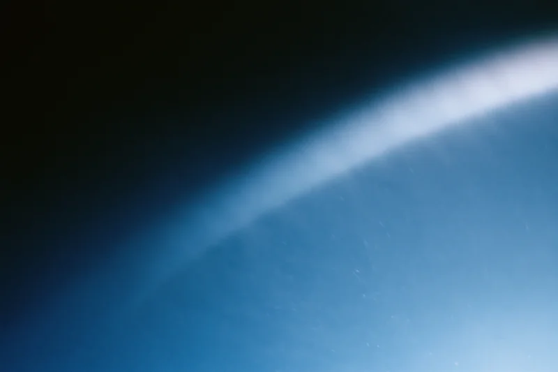 Soft blue light gradient fading from deep navy to bright white across a curved horizon