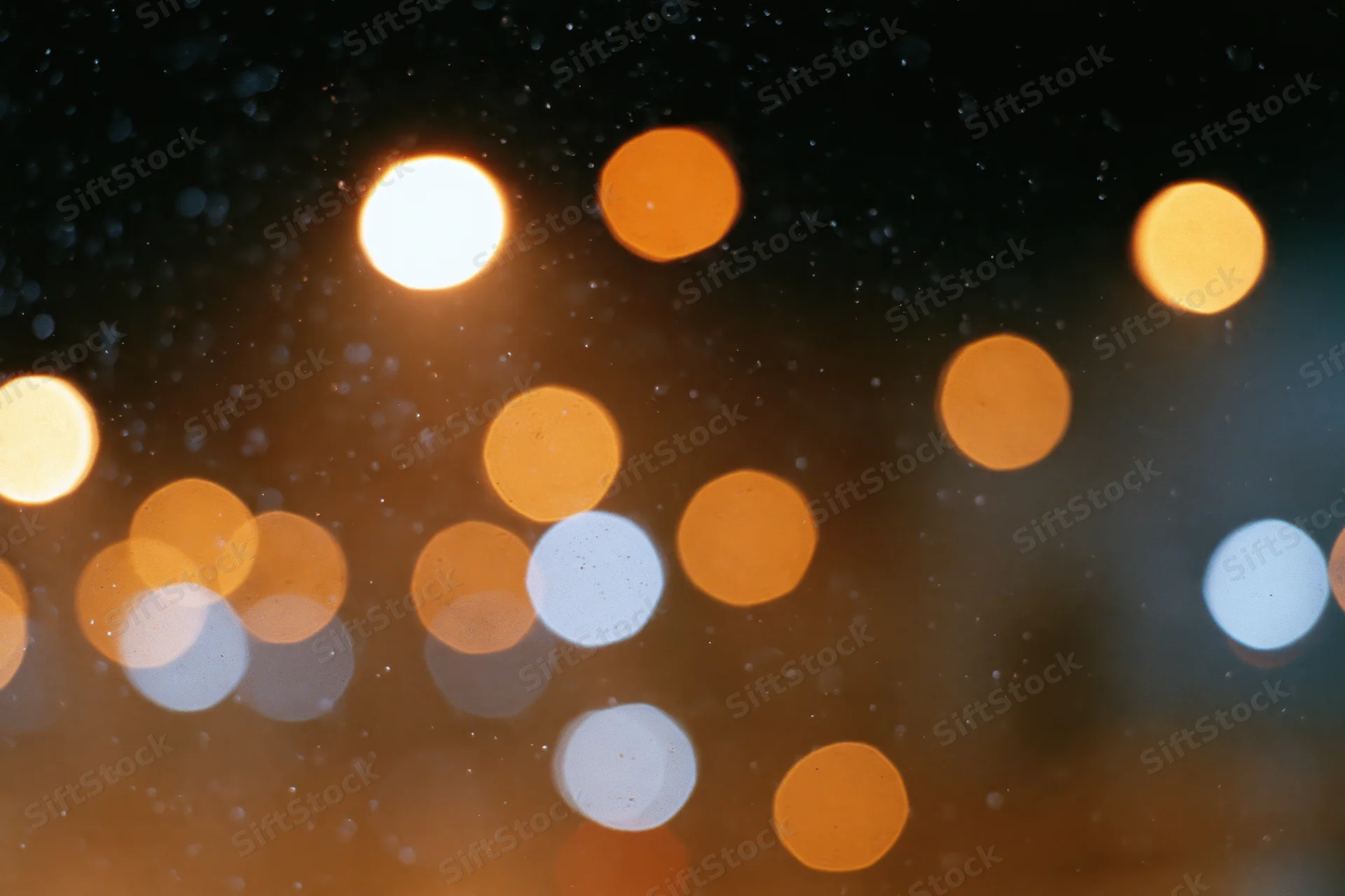 Warm circular bokeh lights blurred in a night city scene with soft glow and copyspace