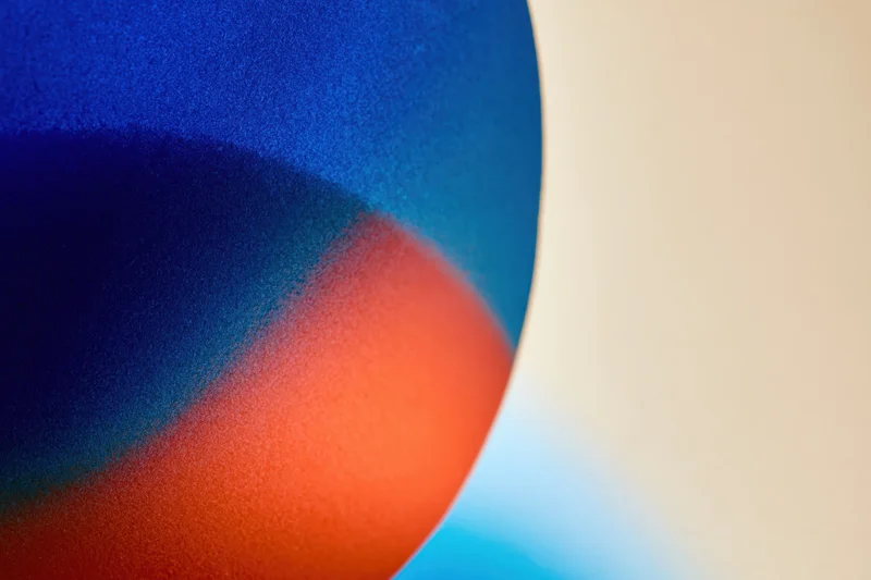 Soft gradient blur of overlapping blue and red colors forming an abstract composition with copyspace