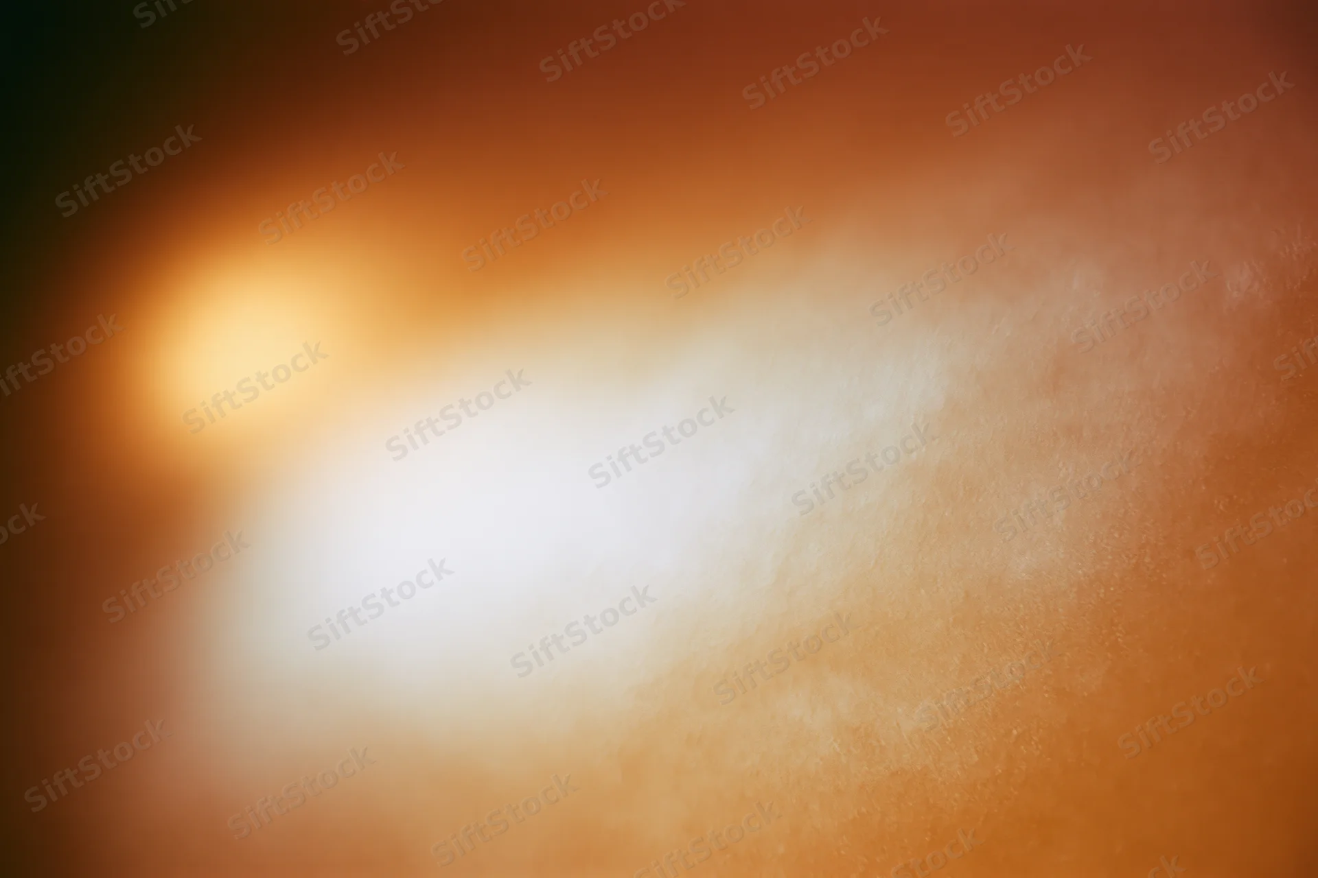 Soft glowing light bloom in warm orange and white gradient background