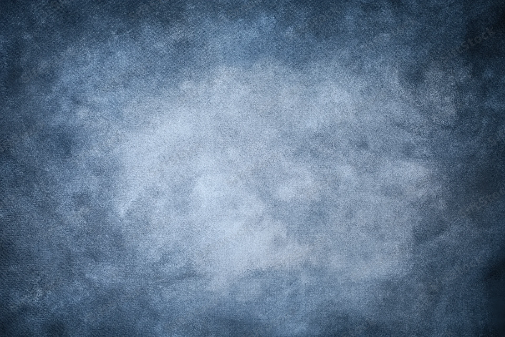 Abstract textured blue-gray backdrop filling the frame with soft light gradient and vignette effect