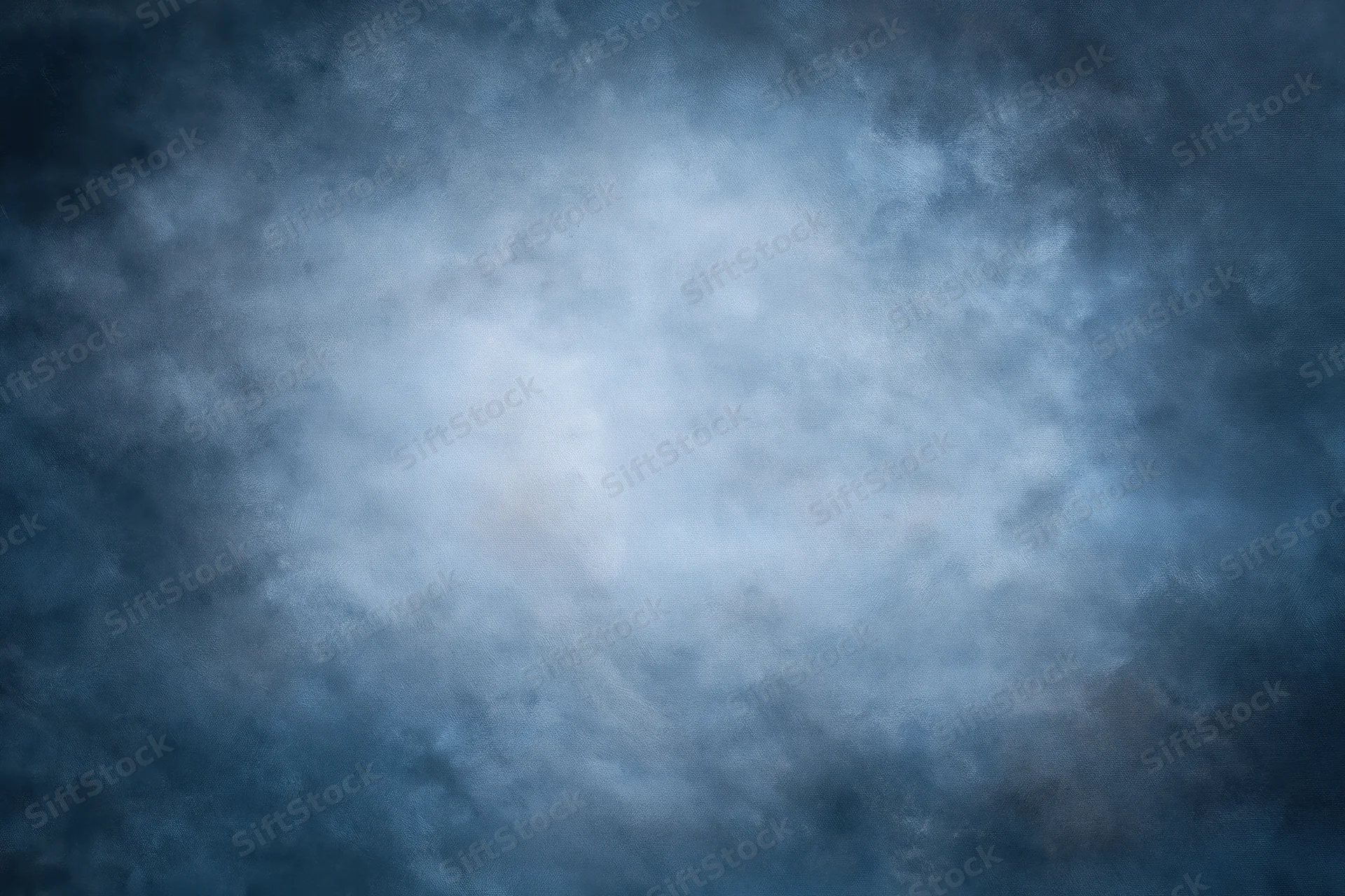 Abstract blue-gray textured backdrop filling the frame with soft atmospheric haze and diffuse light