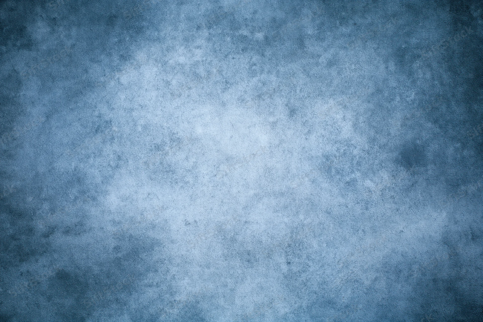 Abstract blue textured backdrop filling the frame in a studio setting