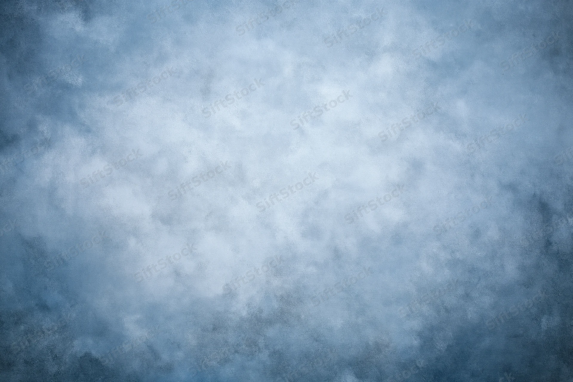 Abstract textured blue-gray backdrop filling the frame with soft mottled surface variation