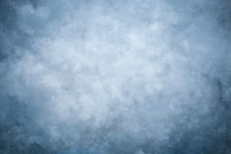 Abstract textured blue-gray backdrop filling the frame with soft mottled surface variation