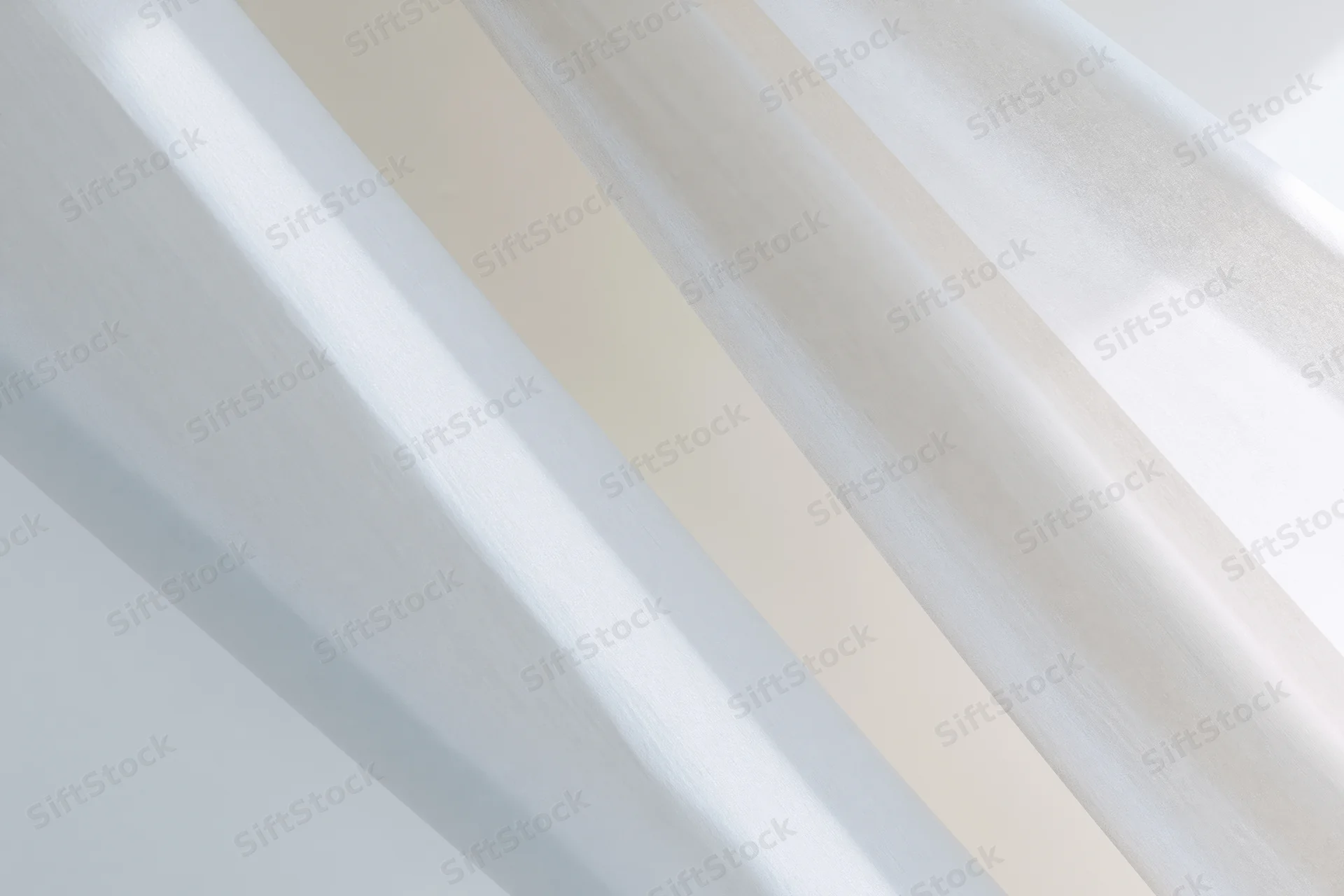 Diagonal white and light grey streaks forming a soft abstract pattern across a smooth surface