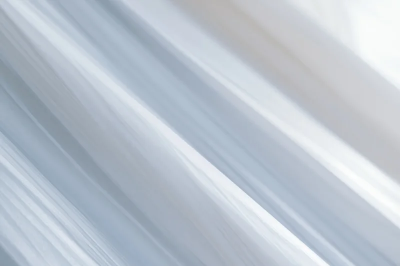 Diagonal white and grey streaks creating a blurred motion effect across the frame