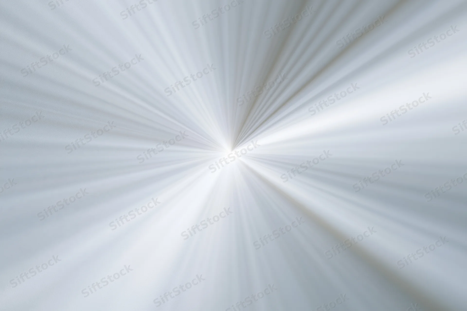 Radial light burst pattern in white and grey with diagonal rays converging at center