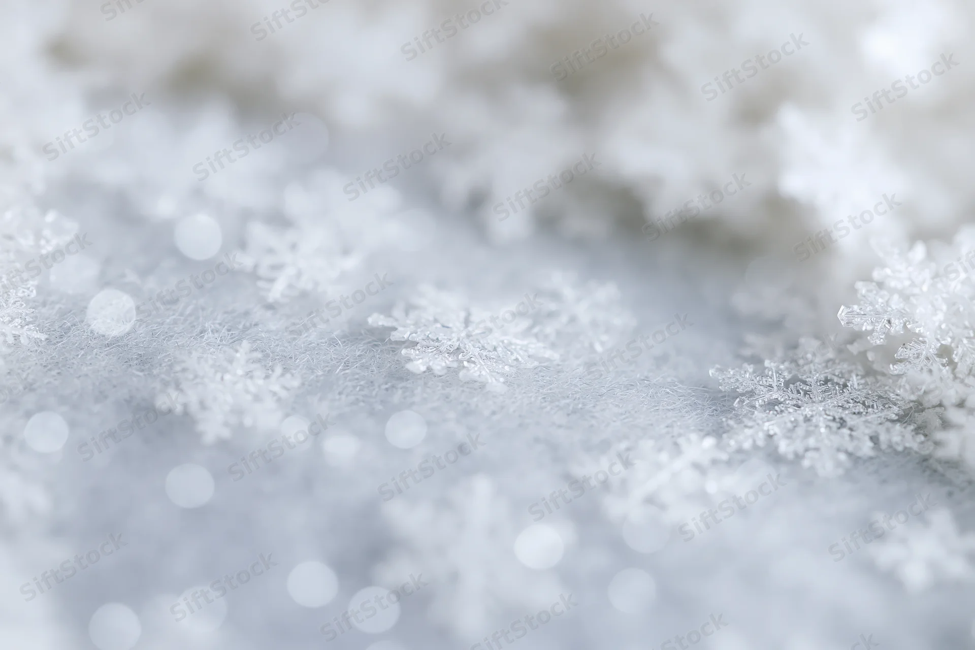 Closeup of delicate snowflakes on a frosty surface with soft bokeh lights