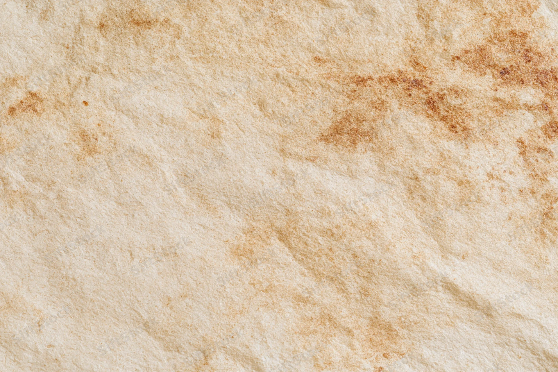 Aged parchment paper surface filling the frame with natural texture and vintage wear