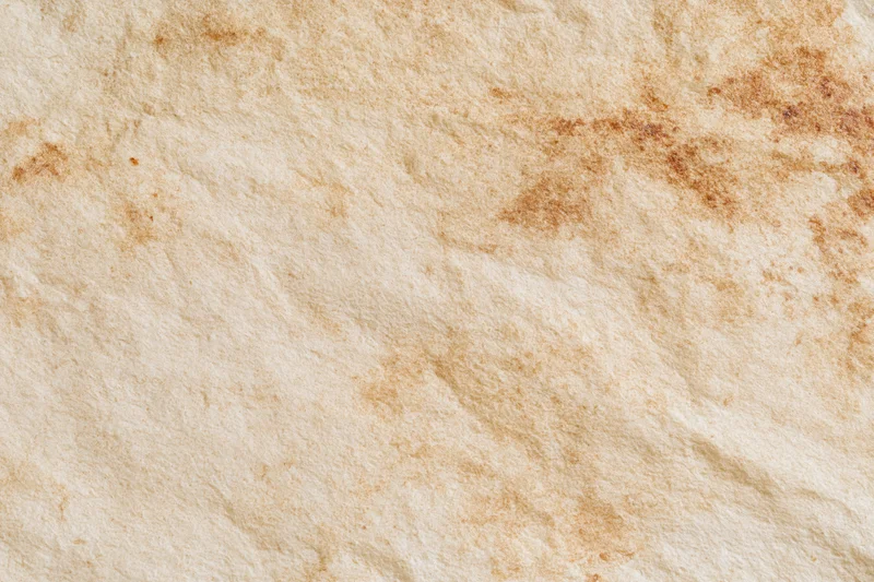 Aged parchment paper surface filling the frame with natural texture and vintage wear