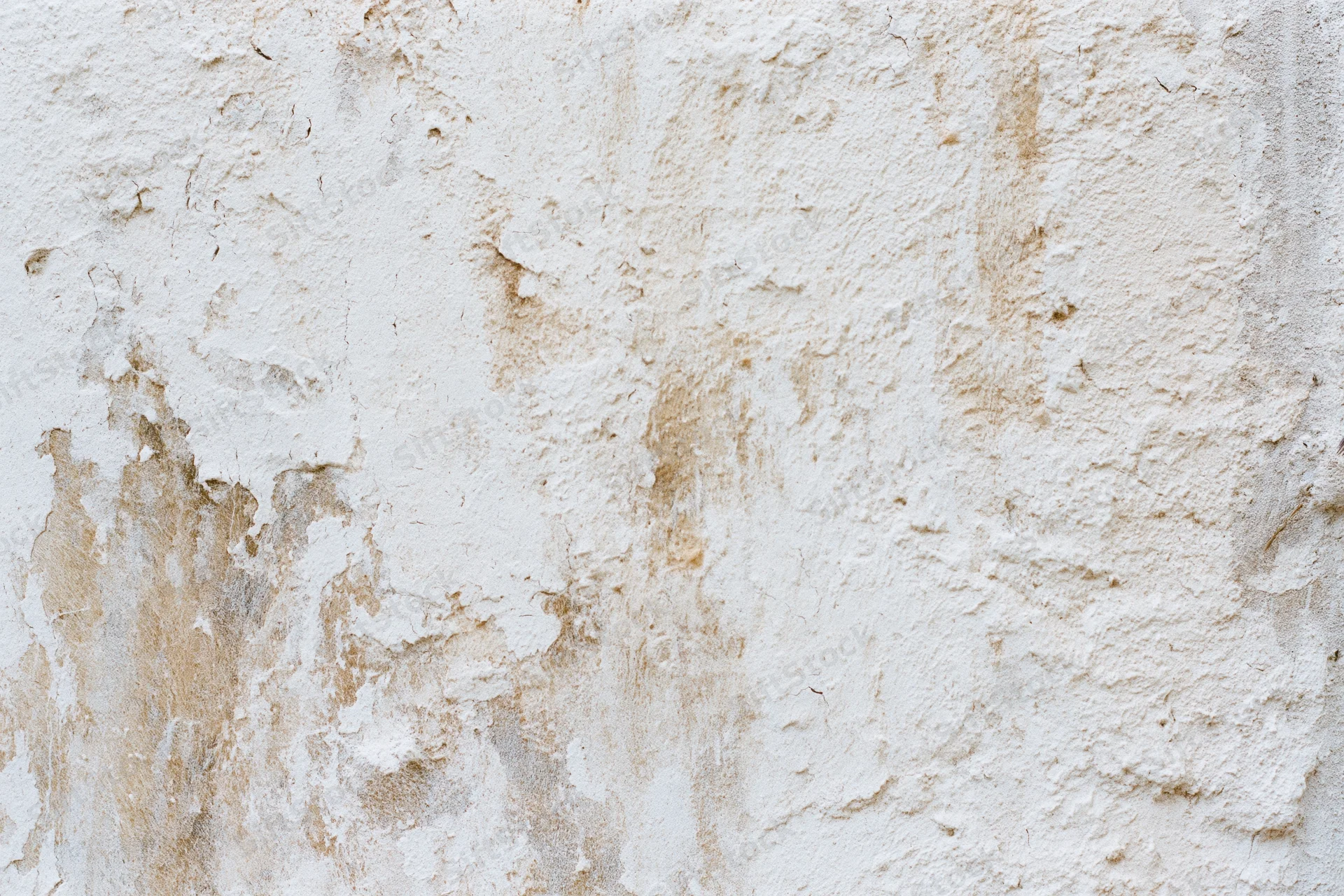 Aged plaster wall surface filling the frame with weathered texture and discoloration