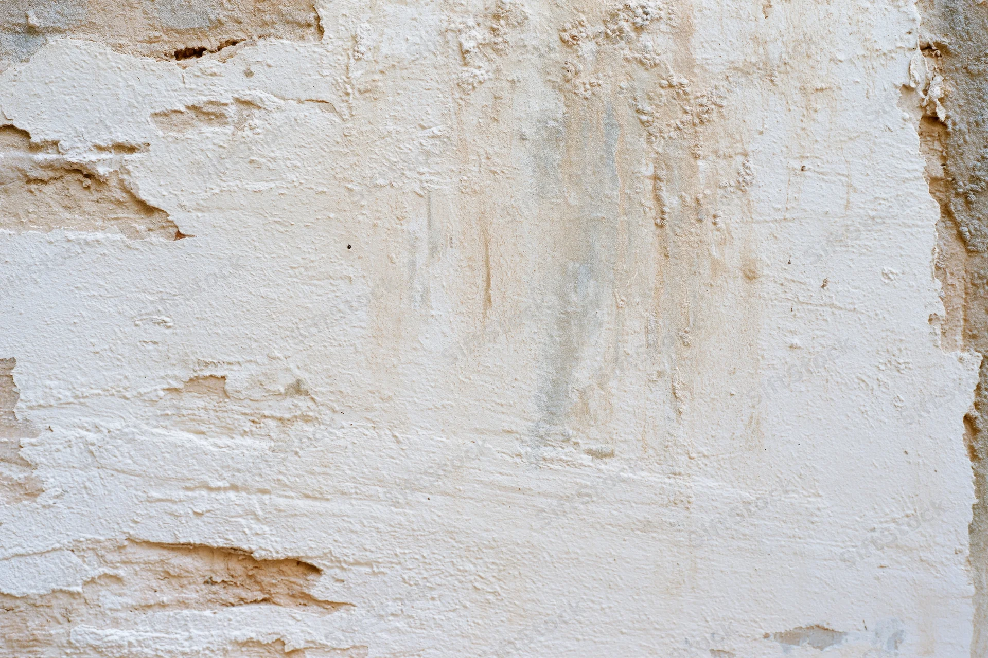 Aged plaster wall surface with peeling paint and cracks filling the frame