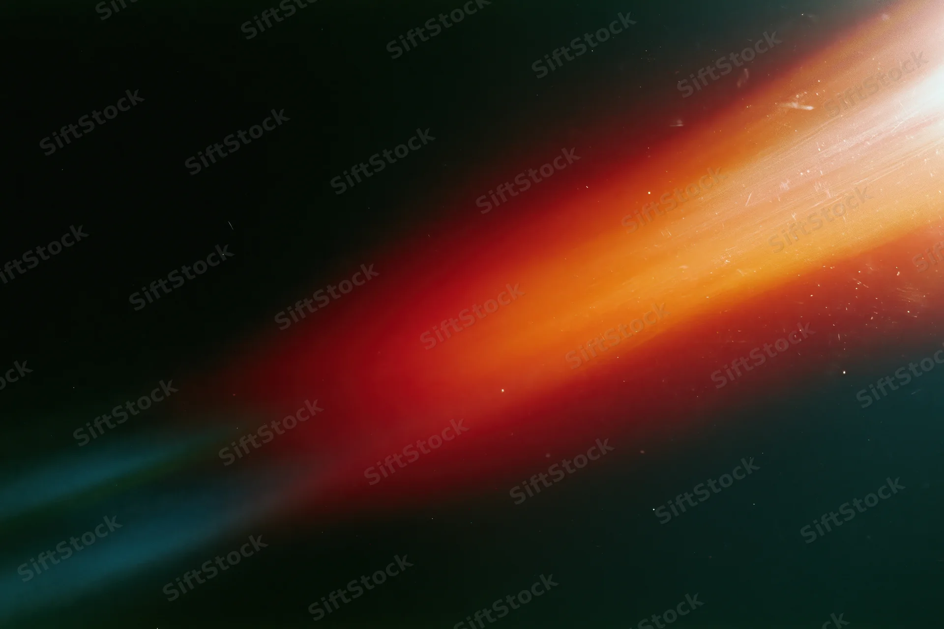 Diagonal light leak overlay on black background with orange red and blue gradient glow