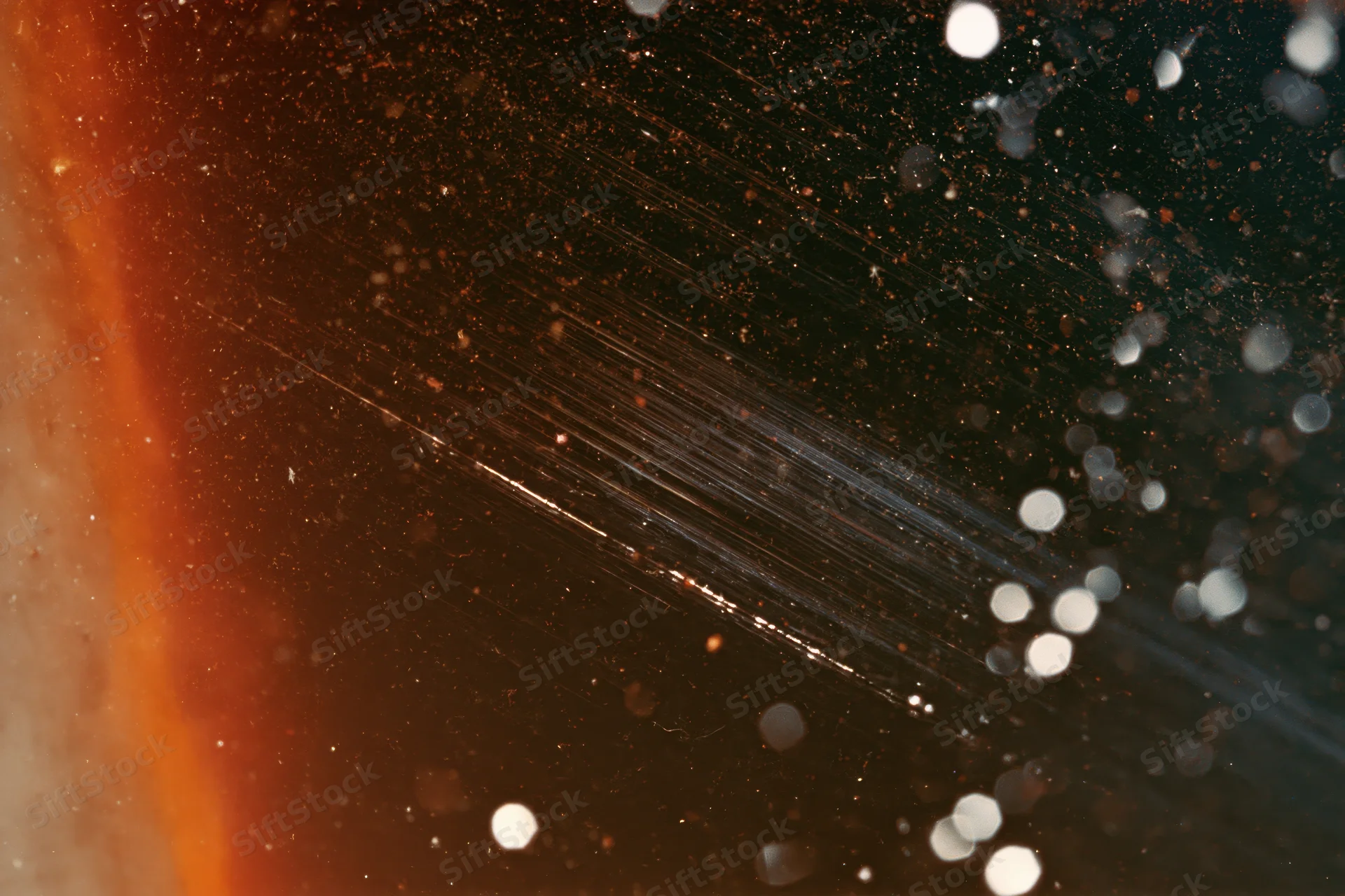 Analog film scan texture with scratches and bokeh light particles on dark background