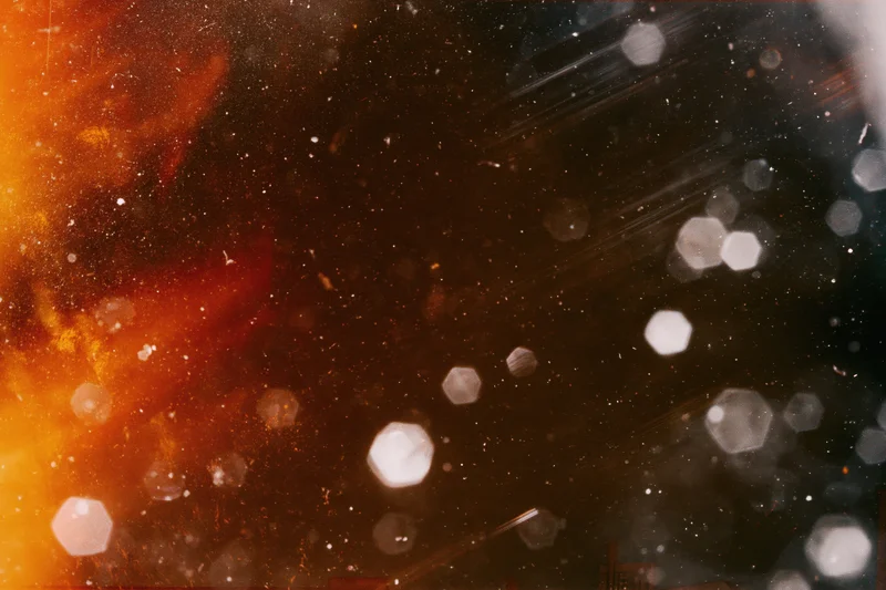 Abstract bokeh pattern with warm glow and film grain texture overlay