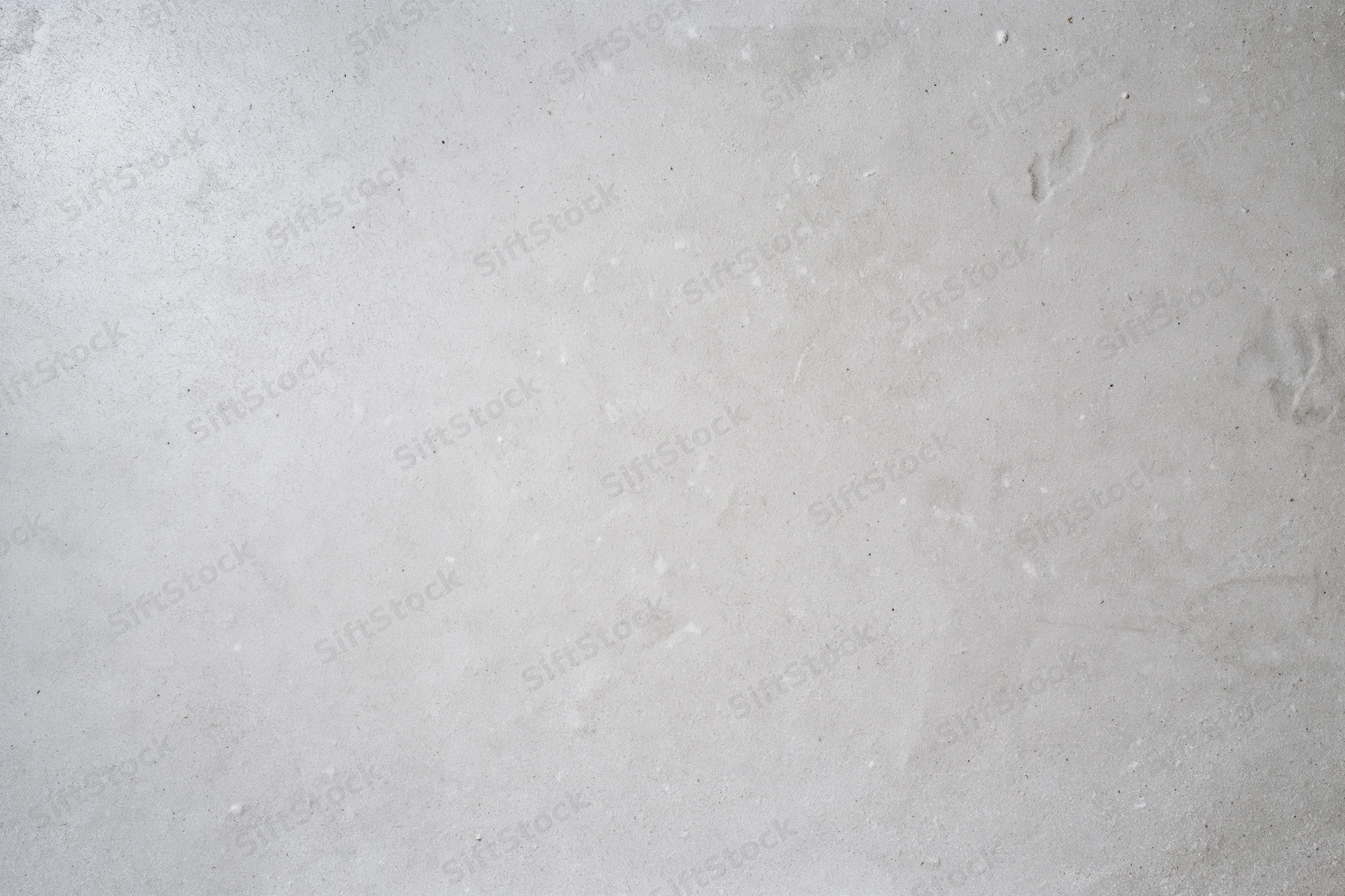 Bare concrete wall surface filling the frame with even texture and neutral gray tone