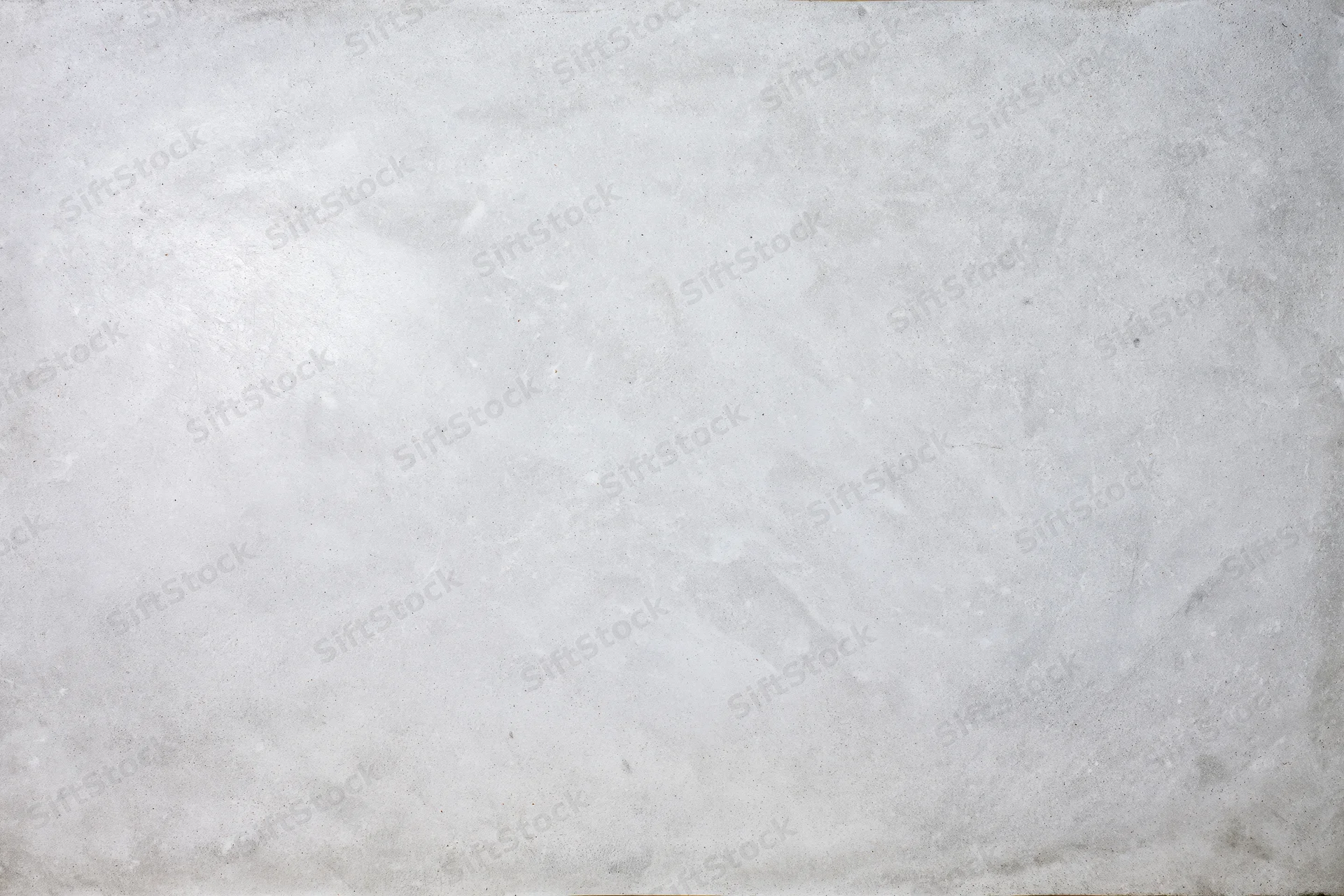 Bare concrete wall surface filling the frame with rough texture and neutral gray tone