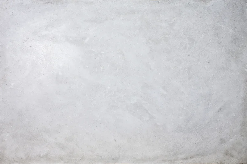 Bare concrete wall surface filling the frame with rough texture and neutral gray tone