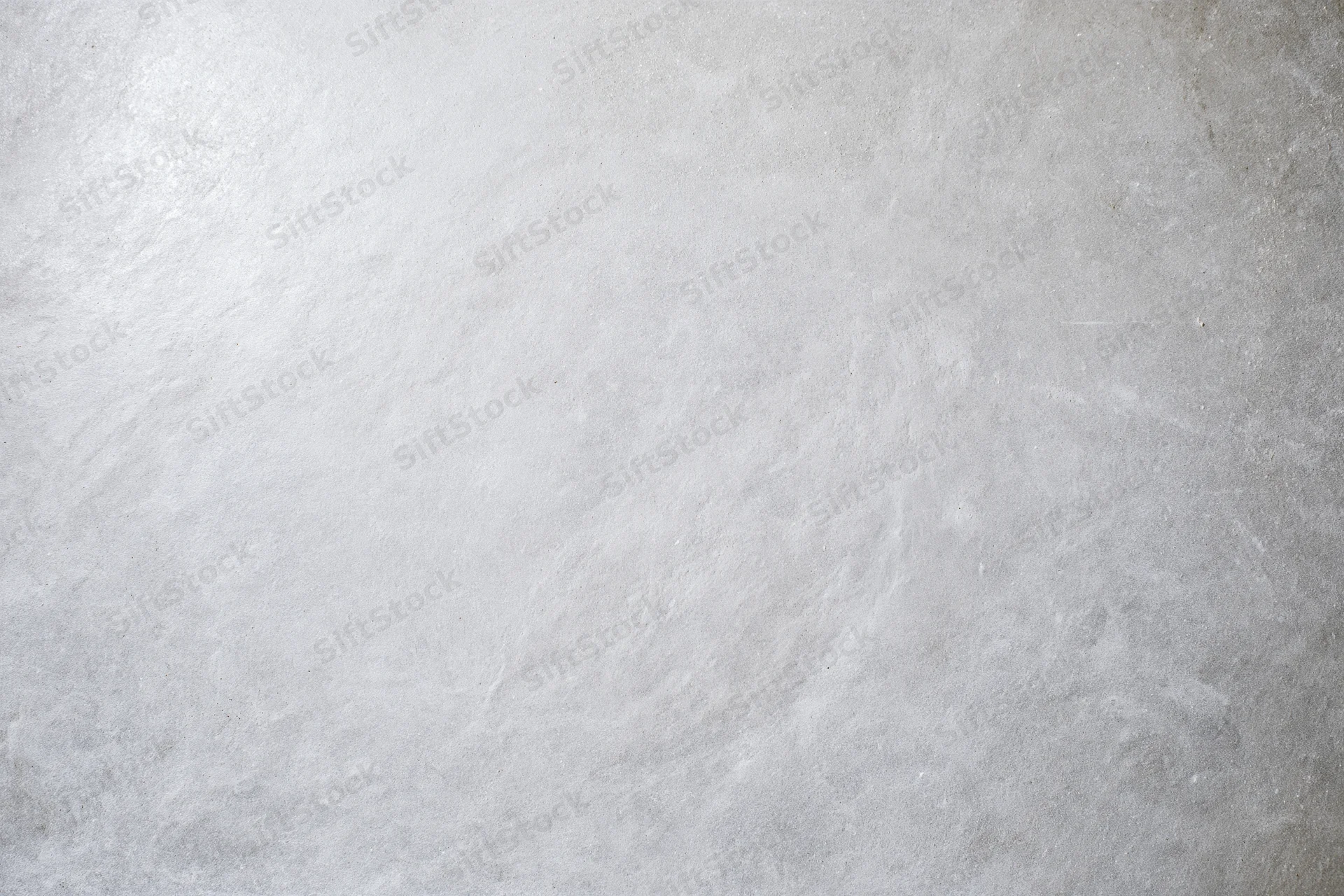 Bare concrete wall surface filling the frame with even texture and neutral gray tone