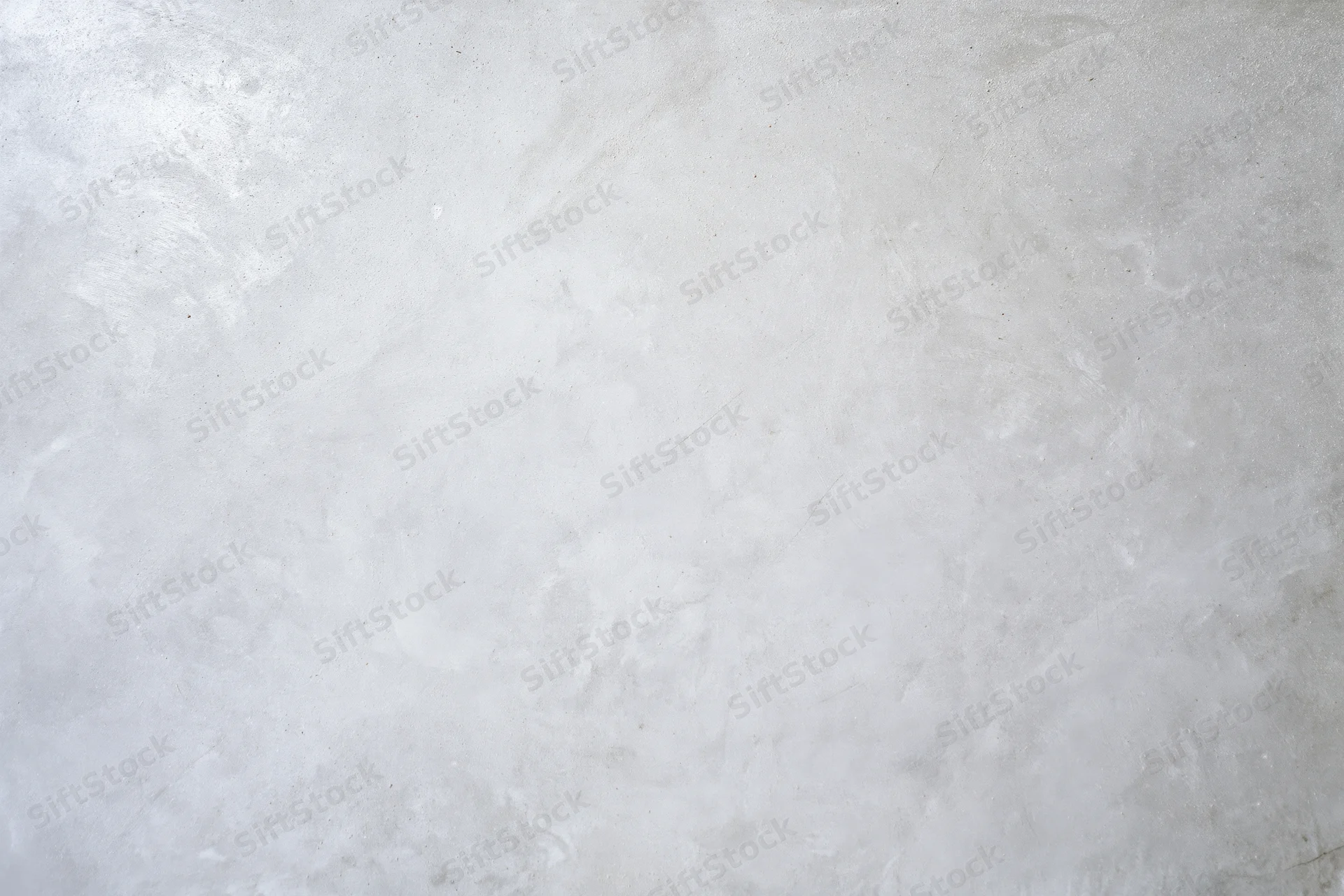 Bare concrete wall surface filling the frame with rough texture and neutral gray tone