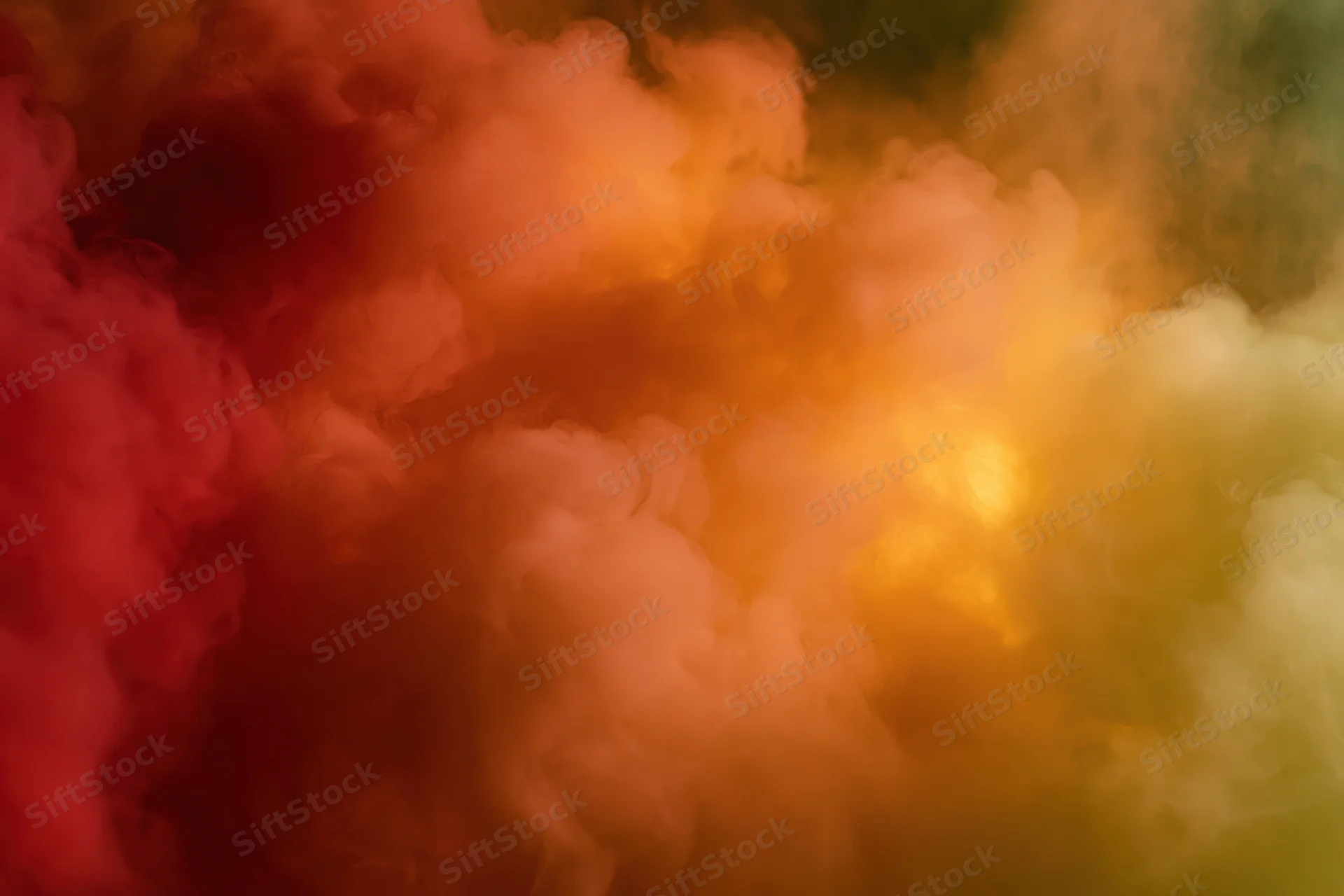 Billowing clouds of colored smoke filling the frame in warm hues