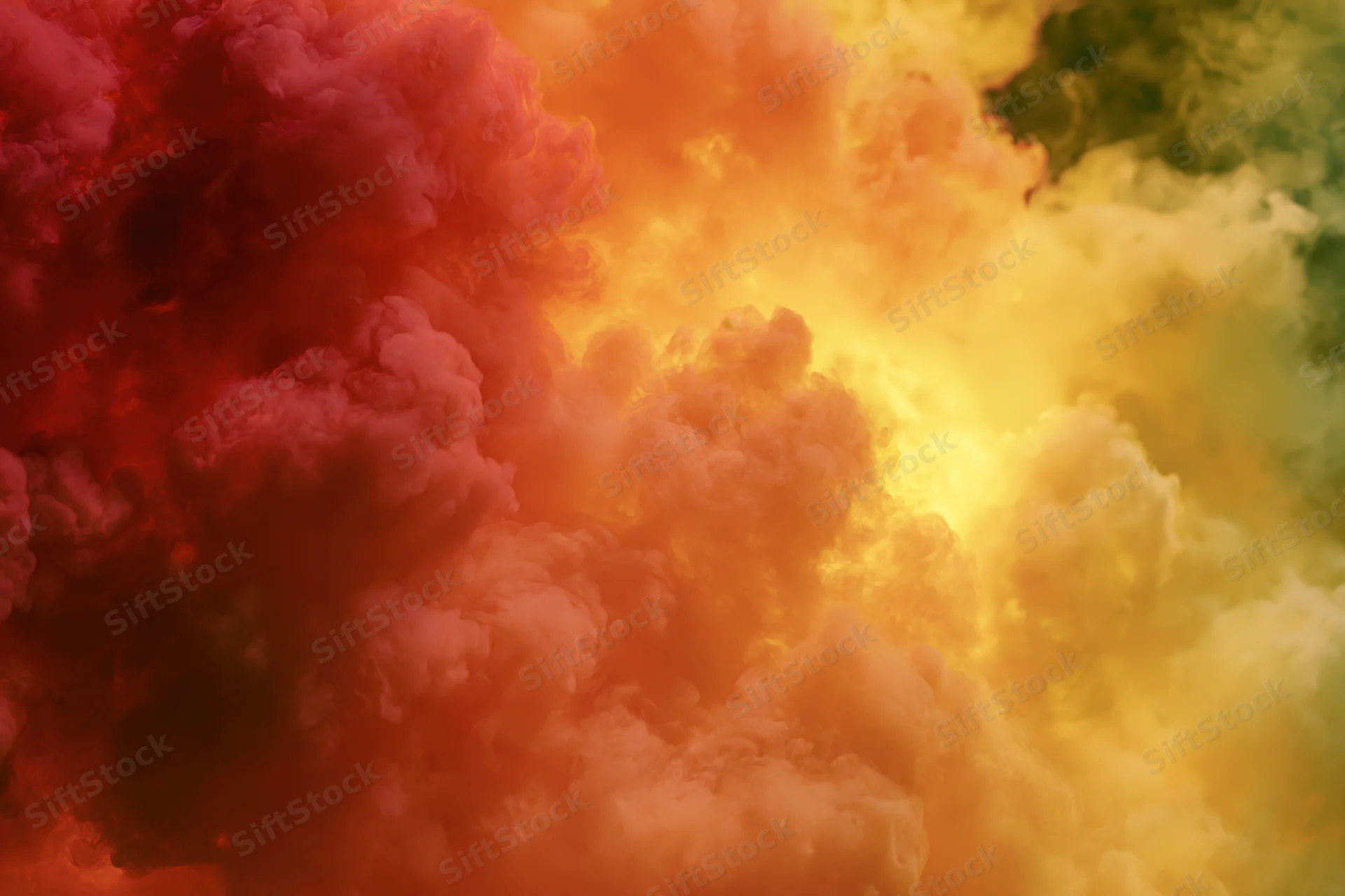 Billowing clouds of colored smoke filling the frame in vibrant red, orange, yellow, and green hues