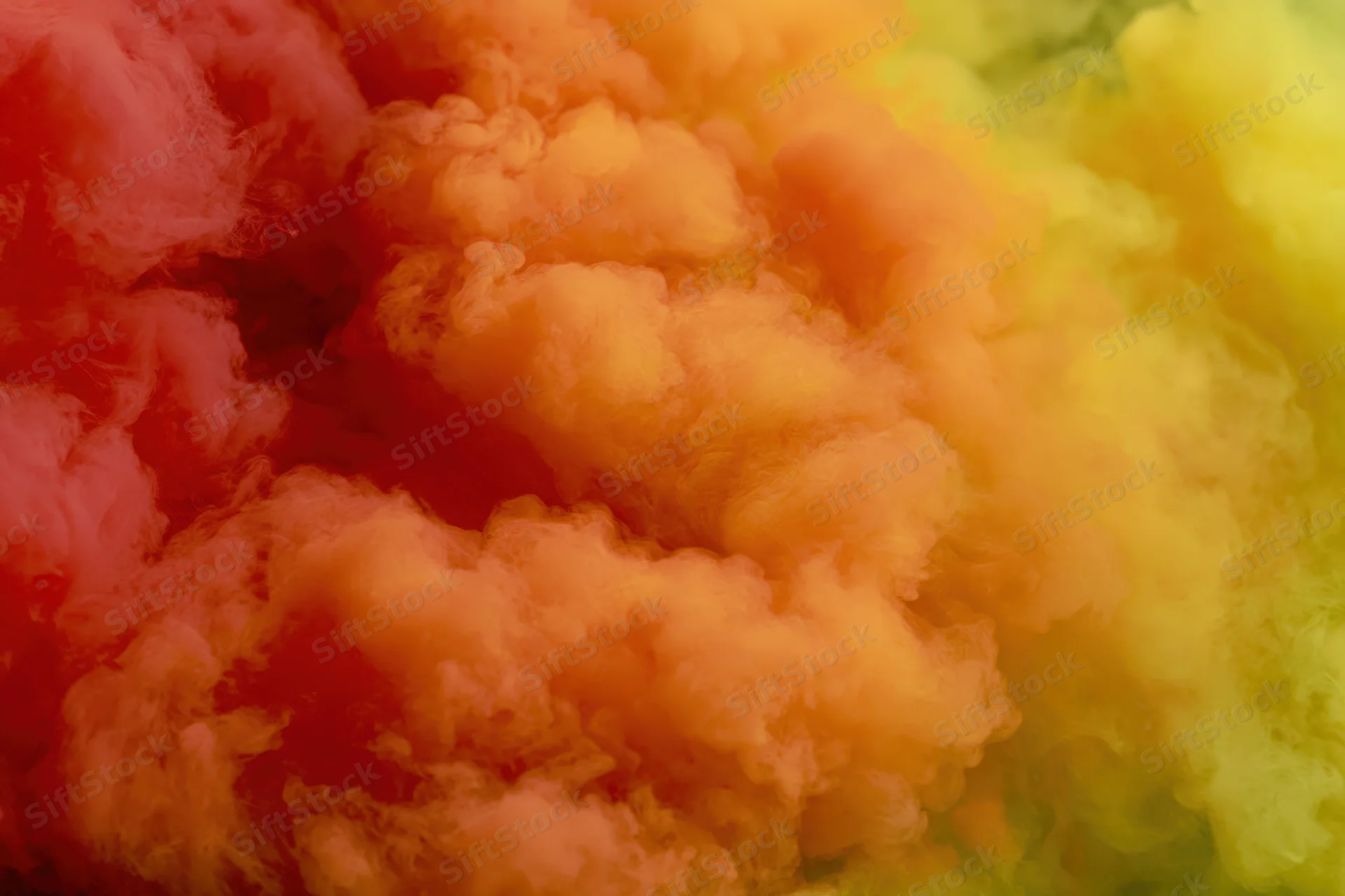 Billowing clouds of red orange and yellow smoke filling the frame