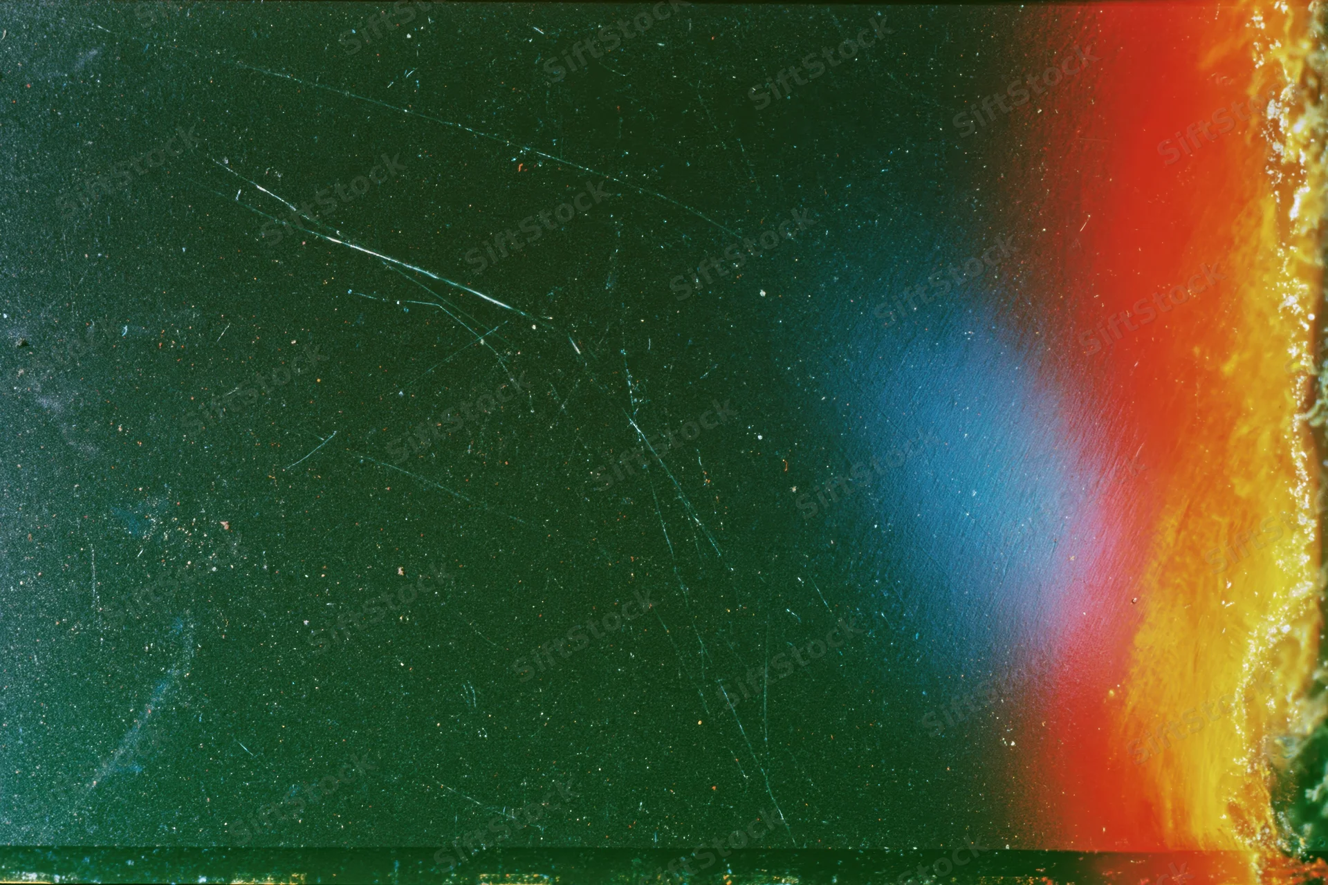 Damaged 35mm film frame with light leak and color gradient across the surface