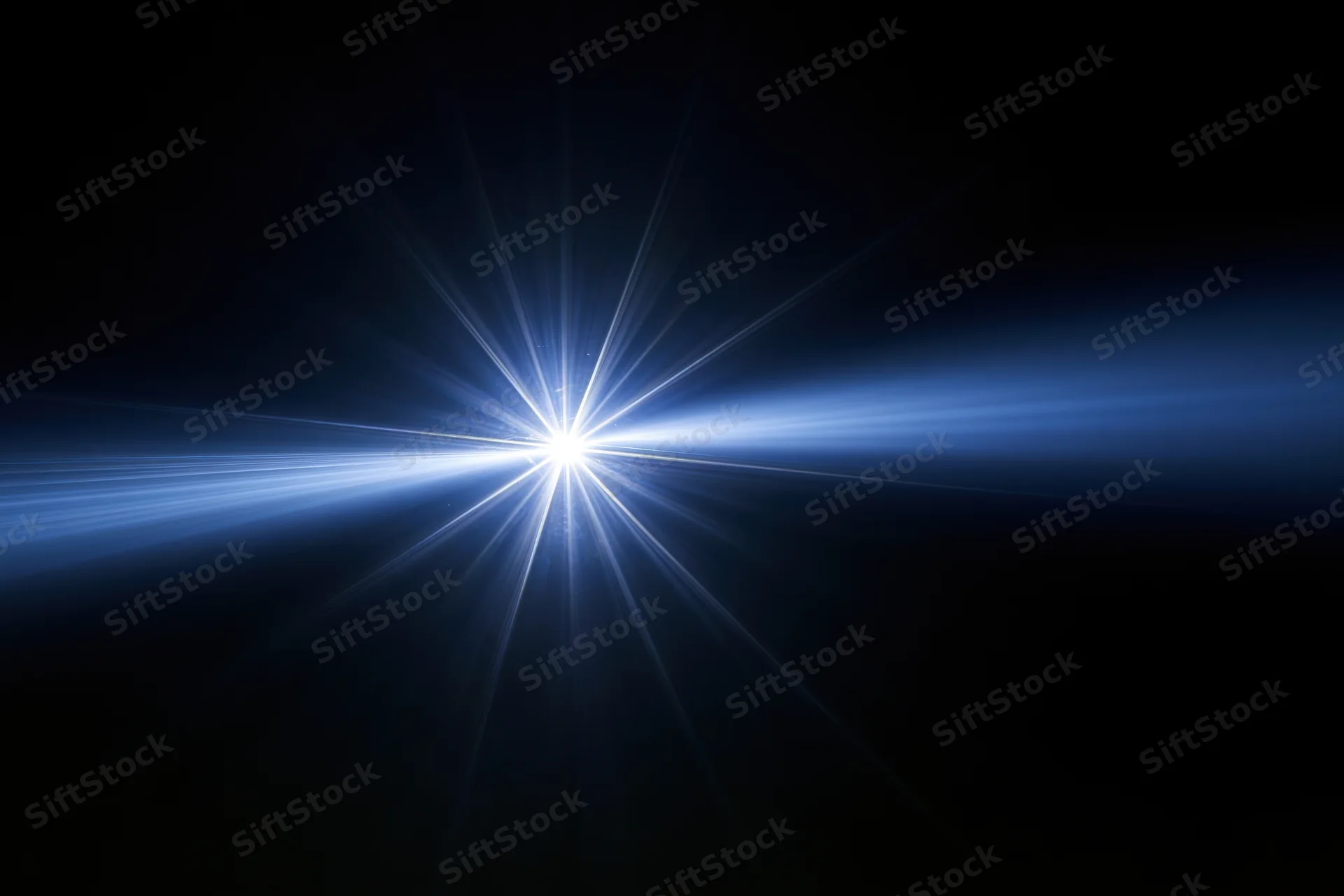 Bright blue-white lens flare burst centered against a deep black background