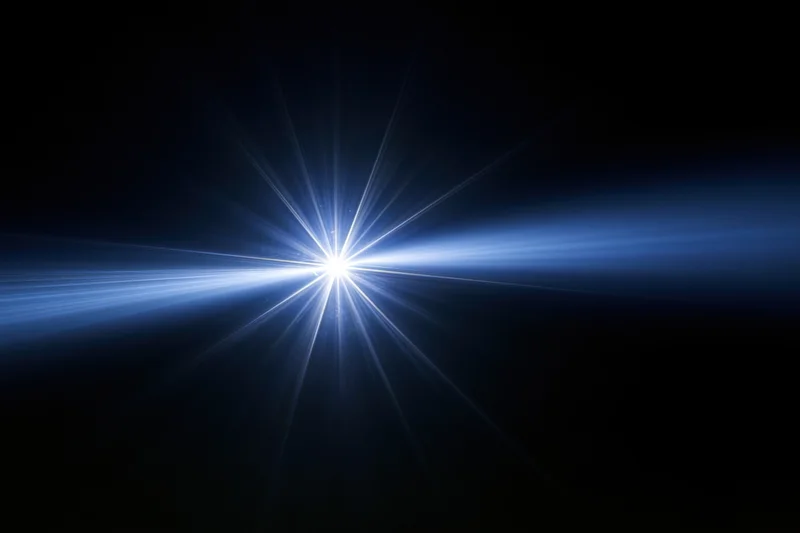 Bright blue-white lens flare burst centered against a deep black background