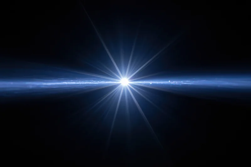 Bright blue-white lens flare burst centered against a dark background with radial light beams