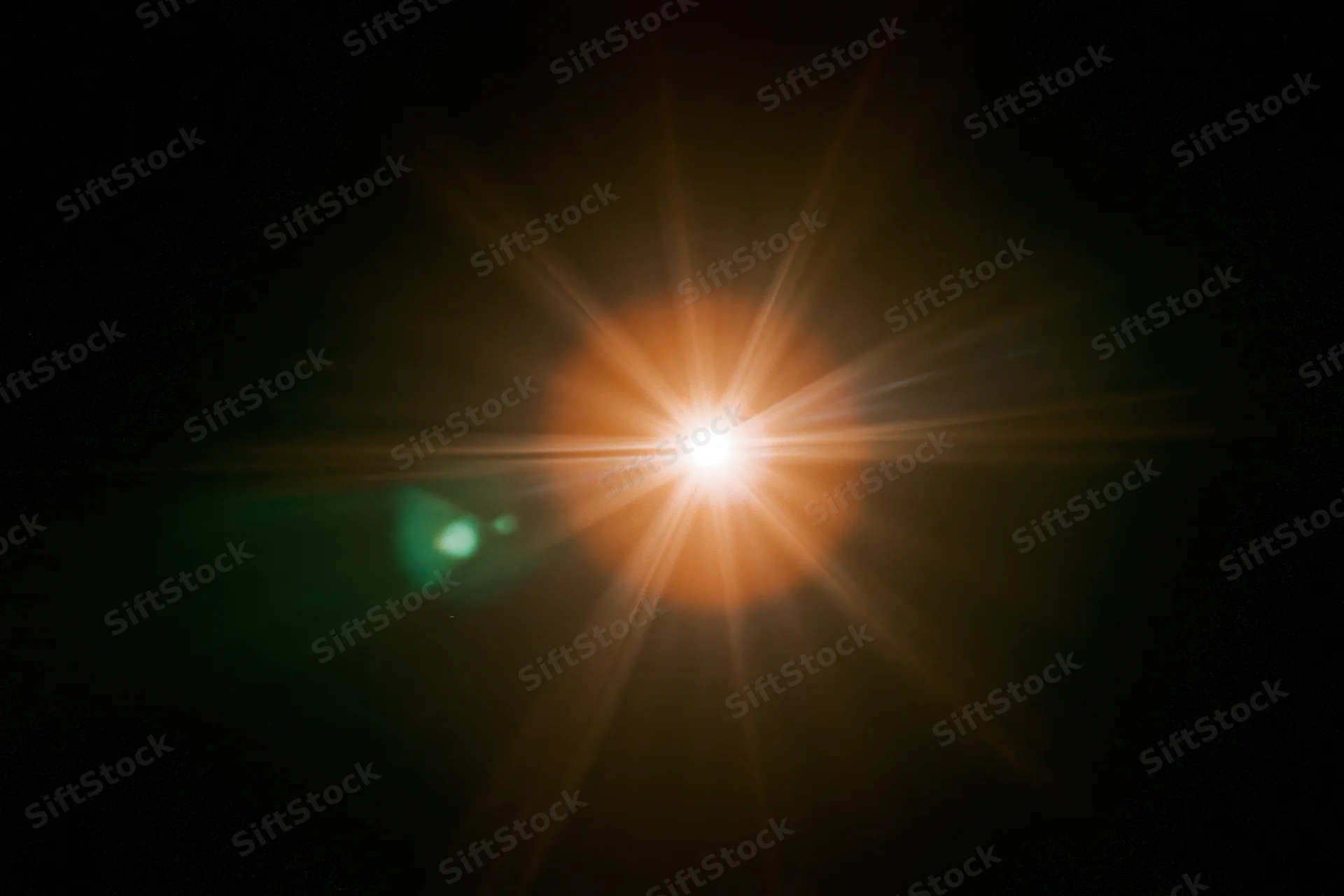 Bright point light source glowing with starburst flare against black background