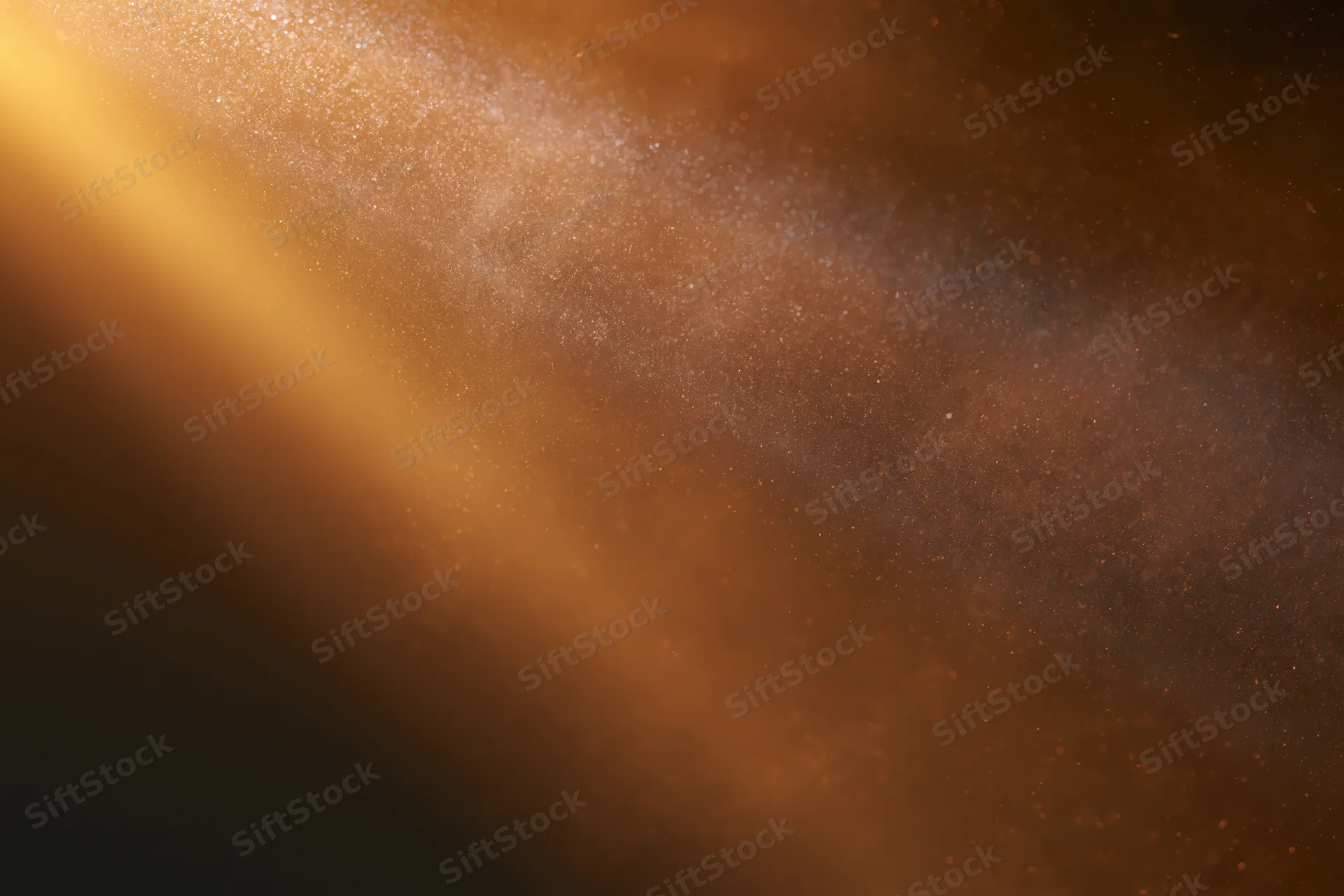 Golden light rays illuminating floating dust particles in a dark space