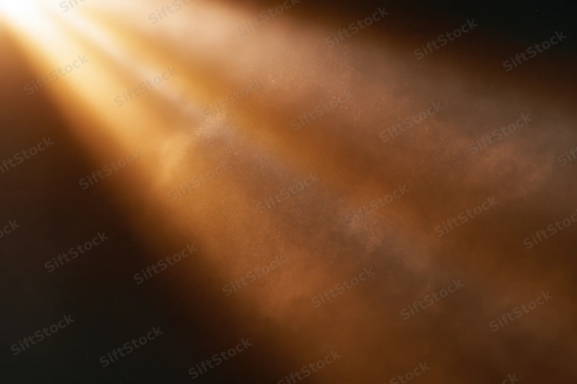 Golden light rays bursting from upper left corner through hazy atmosphere