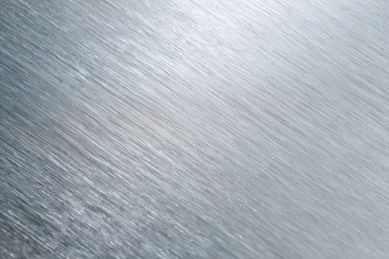 Brushed aluminum metal surface in close-up flat-lay view