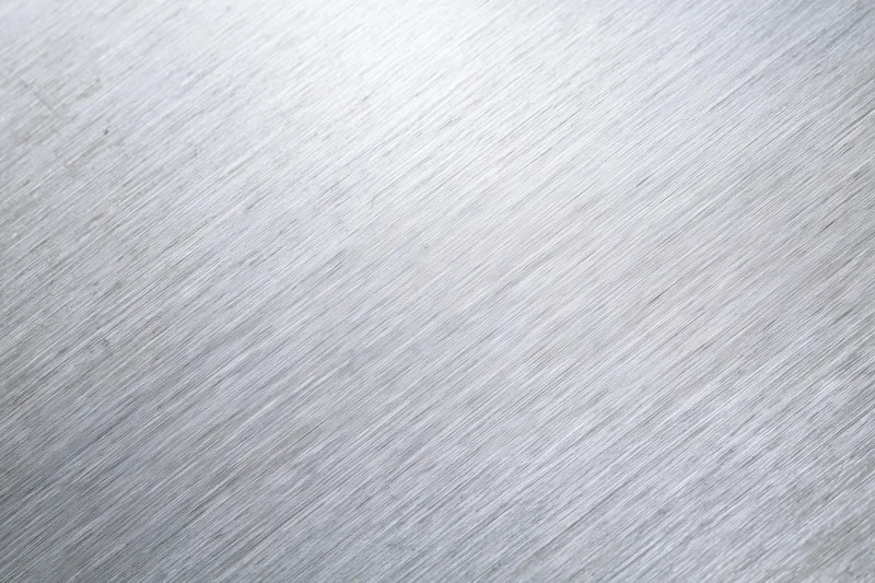 Brushed aluminum metal surface in close-up flat-lay view