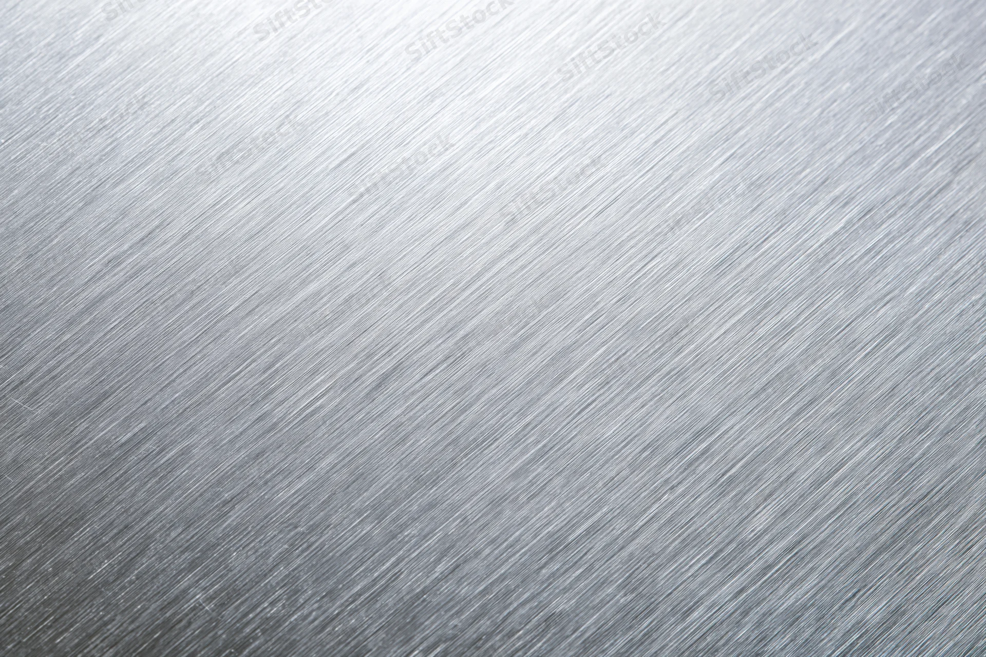 Brushed aluminum metal surface in close-up flat-lay view