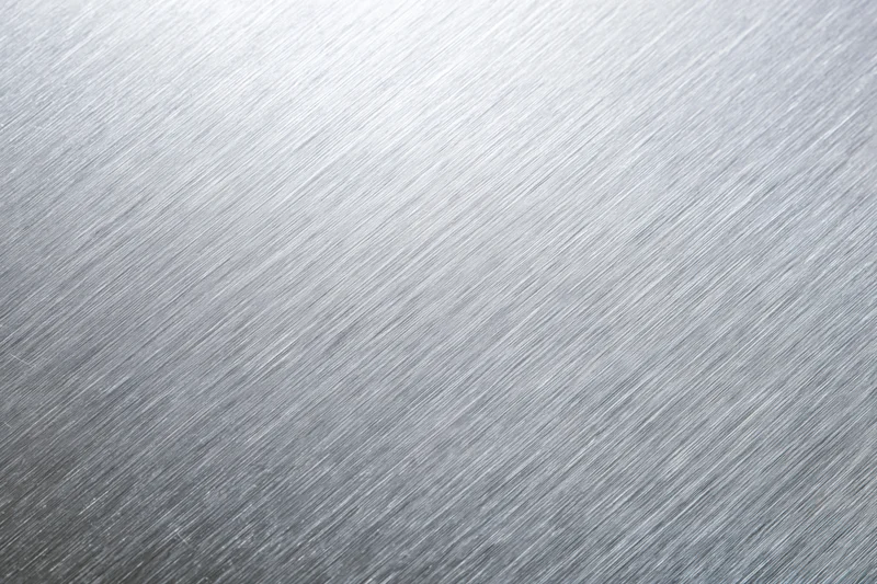 Brushed aluminum metal surface in close-up flat-lay view