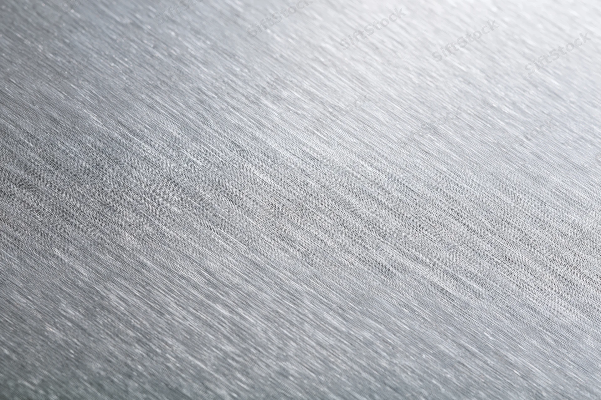 Brushed aluminum metal surface in close-up flat-lay view