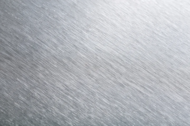 Brushed aluminum metal surface in close-up flat-lay view