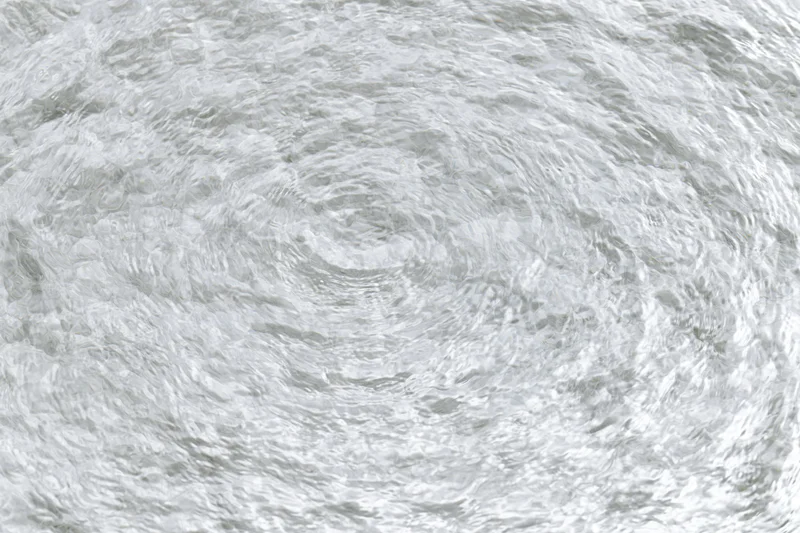 Clear shallow water surface with small ripples viewed from directly above