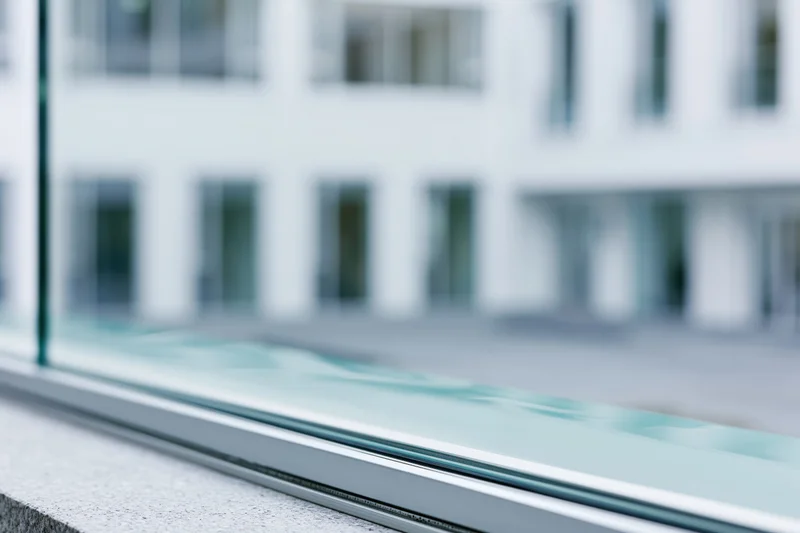 Close-up of glass facade edge on modern office building exterior