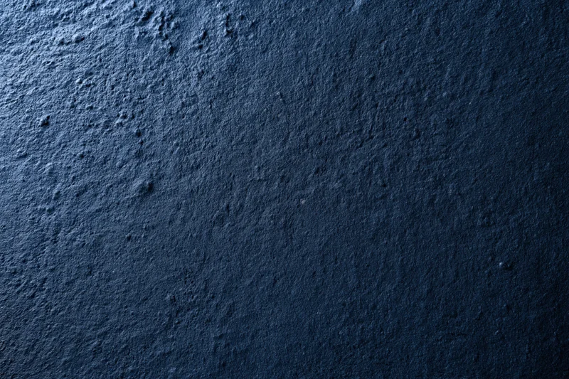 Close-up flat lay of blue textured concrete or plaster