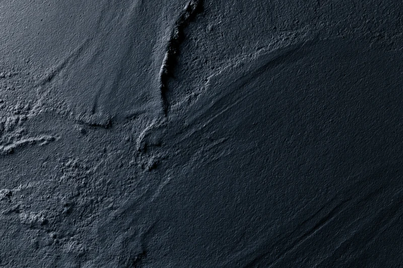 Dark textured concrete wall with cracks and seams in close-up flat lay