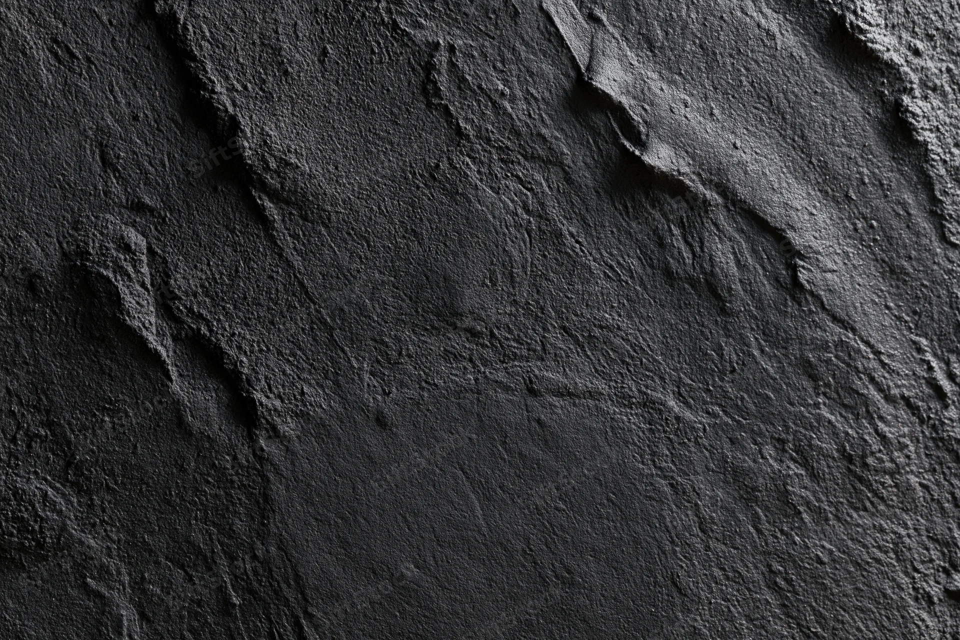Dark textured concrete wall surface in close-up flat lay view