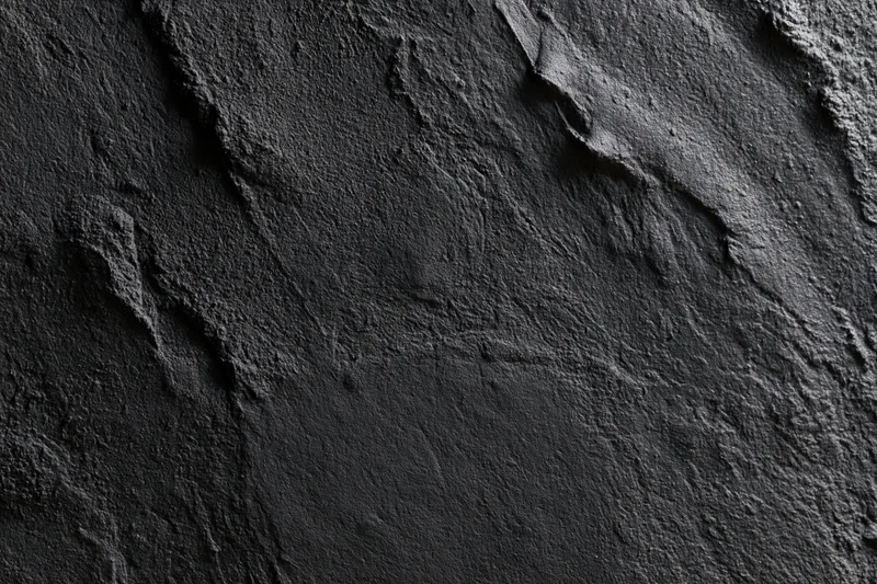 Dark textured concrete wall surface in close-up flat lay view